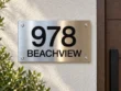 Horizontal Stainless Steel Address Sign - Horizontal brushed stainless steel address sign with black 978 numbers and BEACHVIEW lettering beside a wooden door.