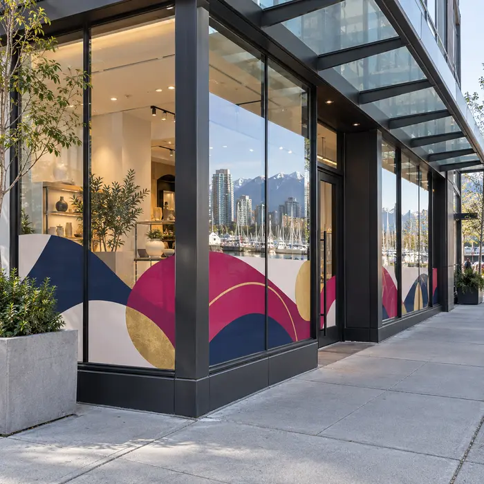 Storefront window graphics mock up with pink, navy and gold geometric designs across the lower glass panels.