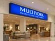 Multiyork indoor light box sign with a blue illuminated face, white lettering, and a dark frame above a furniture showroom entrance.