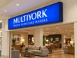 Alternate angled view of the Multiyork indoor light box sign showing its dark cabinet profile, blue face, and white lettering.