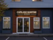 Front view of the Capilano Maritime Design push through light box sign above double doors, framed by wood siding and dark exterior walls.