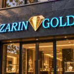 Zarin Gold storefront sign with turquoise illuminated letters and a gold diamond logo above a glass jewellery shop entrance.