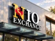 custom channel letter signs - NIO Exchange dimensional storefront sign with white and yellow lettering, black sides, and a red maple leaf logo.