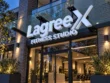 Angled view of the Lagree X Fitness Studio custom channel letter sign, showing white letter faces and dimensional side returns.