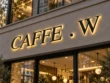 Close-up of the Caffe W backlit channel letter sign highlighting black serif letter edges and warm halo lighting.