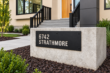Angled view of black 6742 Strathmore cut-out aluminium address sign mounted on a low concrete wall