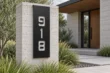 Semi-gloss black vertical address sign 918 mounted on a concrete pillar