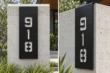 Vertical cut-out aluminum address sign 918 with brushed stainless backing, front and side views