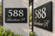 Brushed silver address sign 588 with Barnham Pl on a matte black panel, front and side views