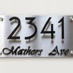 Brushed stainless steel address sign with raised black 2341 Mathers Ave lettering