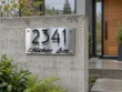 Brushed stainless steel address sign 2341 Mathers Ave mounted on a contemporary concrete wall